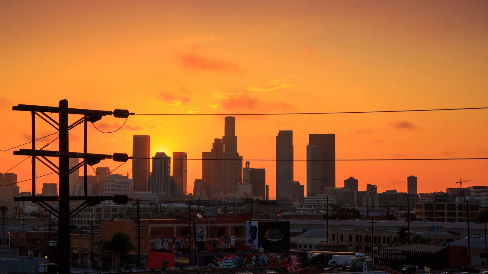 null Skyline sunset with overhead power transmission lines in the foreground